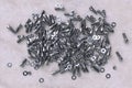 A lot of mounting nuts, bolts and washers on a paper backing. 3d rendering. Industrial background with structural fasteners Royalty Free Stock Photo