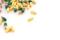 A lot of multi-colored medical capsules with medicine on a white background.