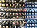 A lot of multi-colored metal cylinders with paint for drawing graffiti of all colors and palettes in the store on the rack. The Royalty Free Stock Photo