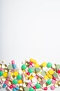 A lot of multi-colored pills on a white background. Royalty Free Stock Photo