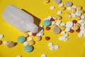 A lot of multi-colored pills on a yellow background Royalty Free Stock Photo