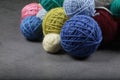 A lot of multi-colored yarn balls on the dark background. Royalty Free Stock Photo