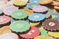 Lot multicolor assorted gambling playing chips surface.