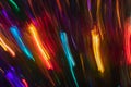 Lot of multicolored blurred diagonal and vertical glowing stripes on dark background