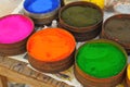 a lot of multicolored paint in jars for makeup artistry