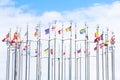 A lot of national flags of european countries on flagpoles abova blue sky