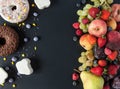 A lot of natural and healthy vitamin fruits, berries vs sweet and junk food on a black background. Vegan eco safe food. The right Royalty Free Stock Photo