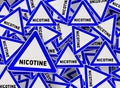 A lot of nicotine triangle road sign