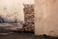 a lot of old bricks stacked on a pallet near the wall of the building Royalty Free Stock Photo