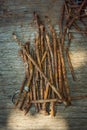 A lot of old rusty bent nails lying on a wooden board Royalty Free Stock Photo