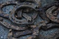 a lot of old rusty horseshoes on a dark photo with blur Royalty Free Stock Photo