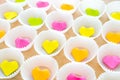 A lot of paper colorful origami heart in round white cupcake molds. Modern bright romantic background. Origami paper hearts Royalty Free Stock Photo