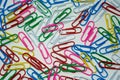 Colored paper clips on white background Royalty Free Stock Photo