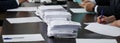 A lot of papers or ballots are on the table, where officials or businessmen are sitting. Counting of votes. Reportage. Panorama Royalty Free Stock Photo