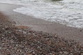 Lot of pebbles on the seashore on a gloomy cold autumn day Royalty Free Stock Photo