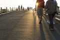 Lot of people are on the bridge, a walk at sunset, bright sun, p