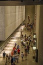 Lot of people, citizens and tourists, visit the interior of the 9/11 National Memorial Museum in New York City - United States of