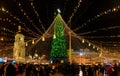Lot of people gathered on the Sofia Square in Kyiv near a large New Year tree with a lot of illumination and light and a