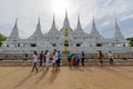 A lot of people light waving rite around the white pagoda of Wat Asokkaram