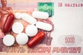 A lot of pills lie on the banknote of five thousand russian rubles.