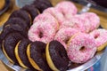 A lot of pink and chocolate donuts