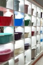 A lot of plastic basins of different colors on open shelves for sale Royalty Free Stock Photo