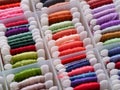 A lot of plastic bobbins with different colour embroidery threads in plastic sorting box Royalty Free Stock Photo