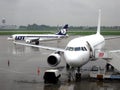 LOT Polish airlines planes at the airport in Warsaw, on a cloudy and rainy day