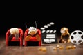 Lot of popcorn figures sitting in a cinema and watching a movie Royalty Free Stock Photo