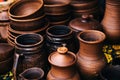 A lot of pottery at the fair. Ceramic national Russian dishes made. Burnt black ceramics. Burnt clay pots and plates, dishesÃÂ¼.