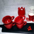 Lot of red colored ceramic coffee cups