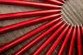 A lot of red pens in a circle on a black wooden background. Concept office or school, knowledge day, the first of September. Royalty Free Stock Photo