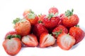 A lot of red super sweet strawberry;s with green tops with two showing off Royalty Free Stock Photo