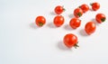 A lot of ripe mini cherry tomato on a white background.