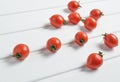 A lot of ripe mini cherry tomato on a white wooden table. Royalty Free Stock Photo