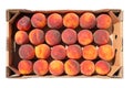 A lot of ripe peaches lies in a cardboard box, harvesting, flat lay, on a white background Royalty Free Stock Photo