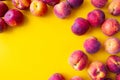 A lot of ripe peaches lined with the edge of a yellow background