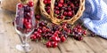 A lot of ripe and sweet cherries, on the table and in a glass, for traditional Belgian beer. Delicious red berries. Copy space