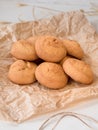 a lot of round cheese biscuit biscuits on crumpled parchment paper and a scourge Royalty Free Stock Photo