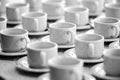 A lot of rows of pure white cups with plates for coffee or tea break Royalty Free Stock Photo