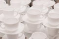 a lot of rows of pure white cups with plates for coffee or tea break . High quality photo Royalty Free Stock Photo