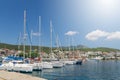 A lot of sailboats anchored in a port in town