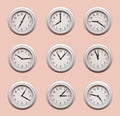 A lot of same clocks showing different times hanging on the pale orange wall Royalty Free Stock Photo