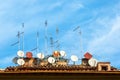 A lot of satellite dish antennas on the house against blue sky background in Italy Royalty Free Stock Photo