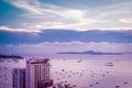 Lot of ship or boat on the sea ocean of Pattaya bay and city in Thailand. At Sunset