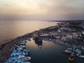 A lot of ships are in the port near the shore on the background of a beautiful sunset. Mediterranean coast of Cyprus Royalty Free Stock Photo