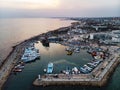 A lot of ships are in the port near the shore on the background of a beautiful sunset. Mediterranean coast of Cyprus, Ayia NAPA Royalty Free Stock Photo