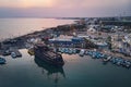 A lot of ships are in the port near the shore on the background of a beautiful sunset. Mediterranean coast of Cyprus, Ayia NAPA Royalty Free Stock Photo