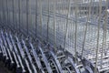 A lot of shopping trolleys. Modern supermarket shopping carts in a row