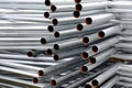 A lot of silver iron pipes piled up.